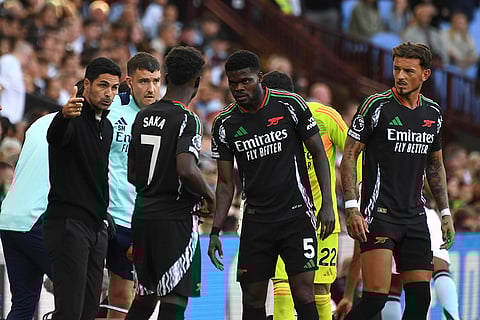 Premier League 2024-25: Arsenal's manager Mikel Arteta, left, talk to his players match against Aston Villa